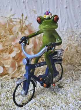Gl&uuml;cksfrosch Fahrradfahrer mit blauem Fahrrad